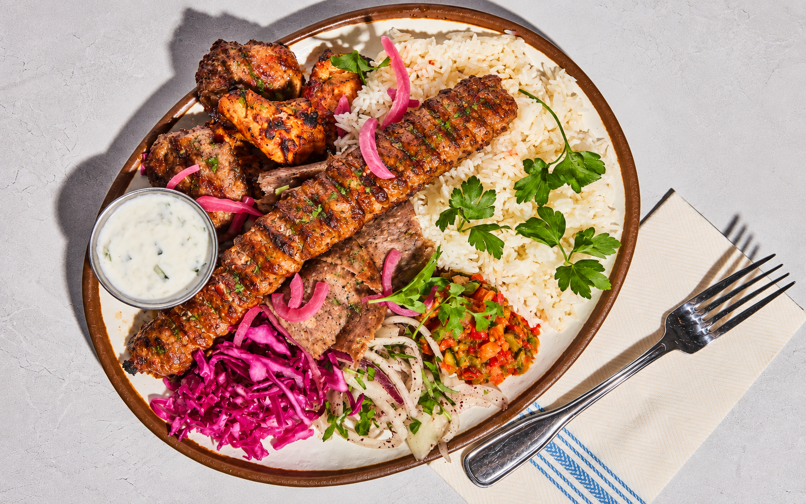 MezzeMe mixed kebap plate with grilled meats, rice and fresh sides